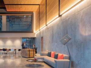 Reception sofa bamboo interior lighting desk double-height concrete